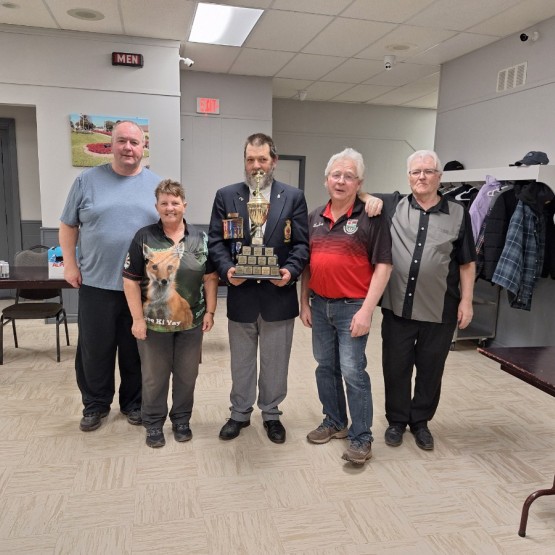 Comrade Gordon Perry presenting the 2025 Senior Darts Trophy to  winners  Lloyd Philips, Bill Durant, Gordan and Myrna Millar.